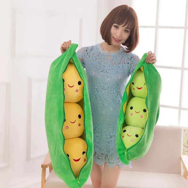 Woman holding two kawaii plush pea pods with smiling peas inside against a white background