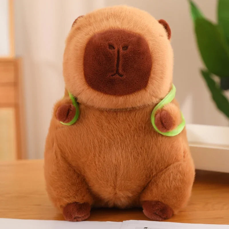 Brown kawaii plush toy resembling a bear with green accents on a wooden surface.