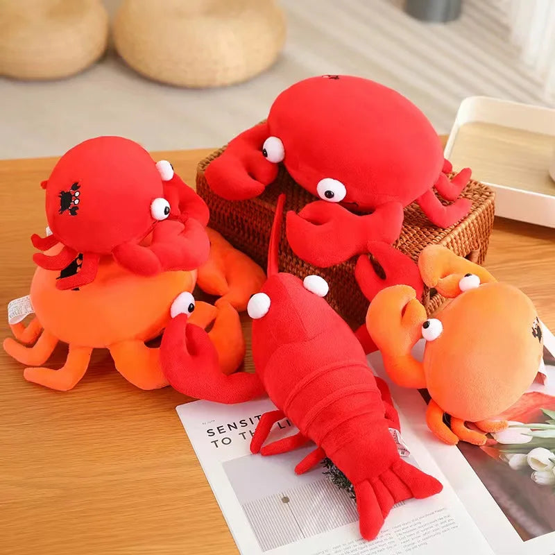 Set of red and orange kawaii plush toys resembling crabs and lobsters on a wooden surface.