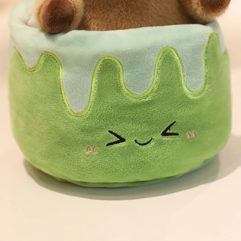 Green kawaii plush toy resembling a cake with a face on a beige background