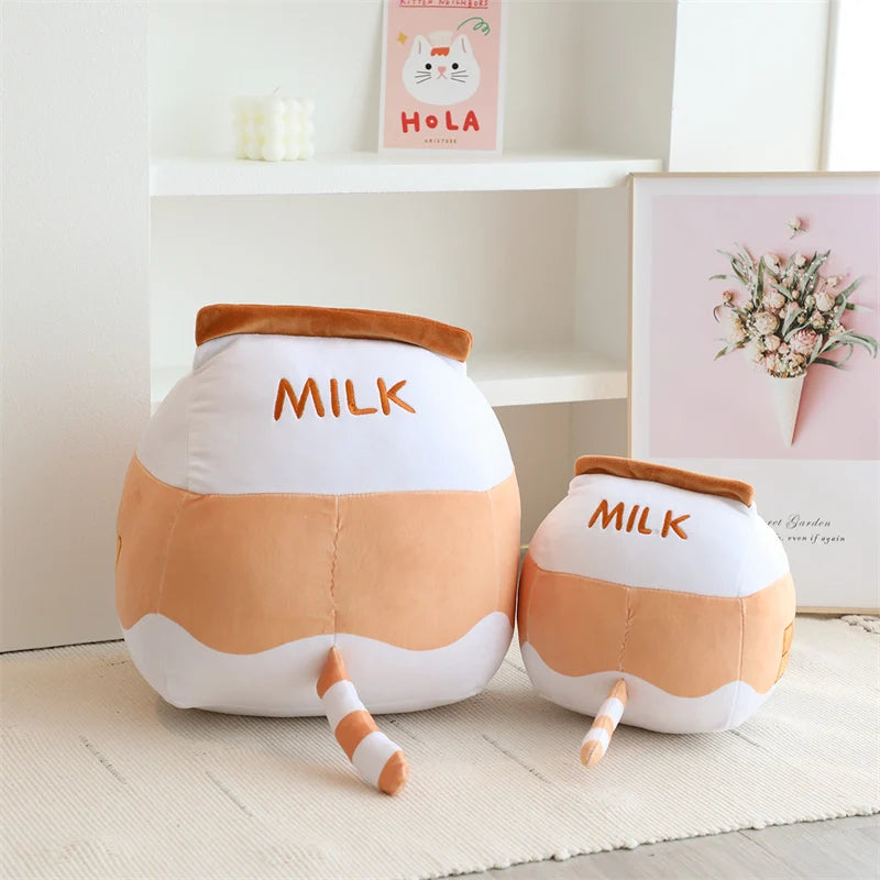 Two milk carton-shaped kawaii plush toys on a light wooden floor with a neutral background.