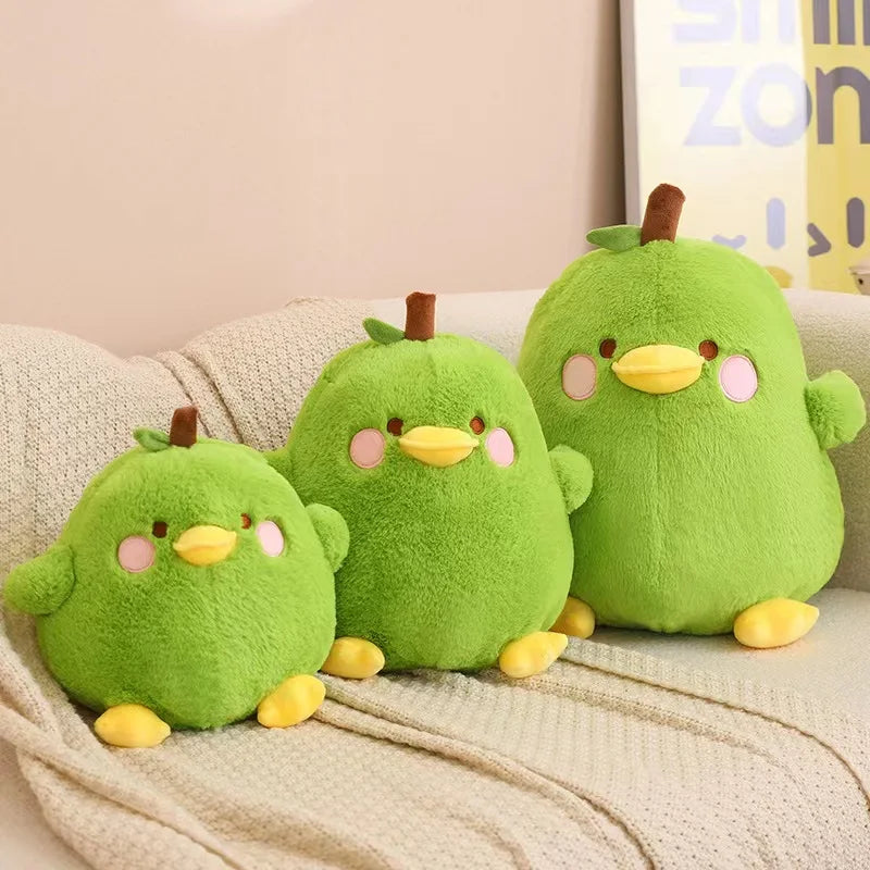 Three green kawaii plush toys resembling birds on a beige couch.