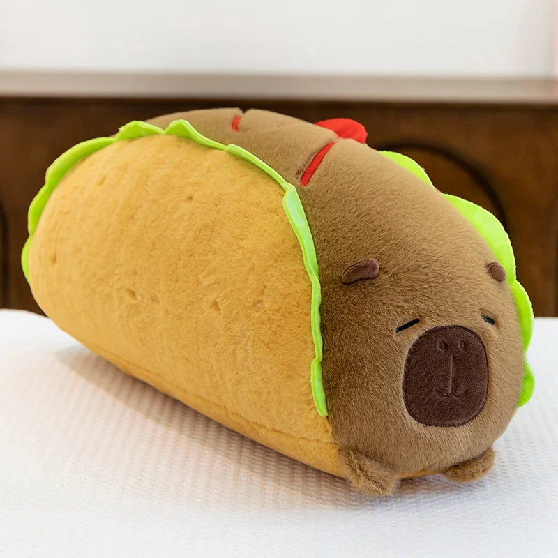 Kawaii plush toy shaped like a taco with a face on a white surface