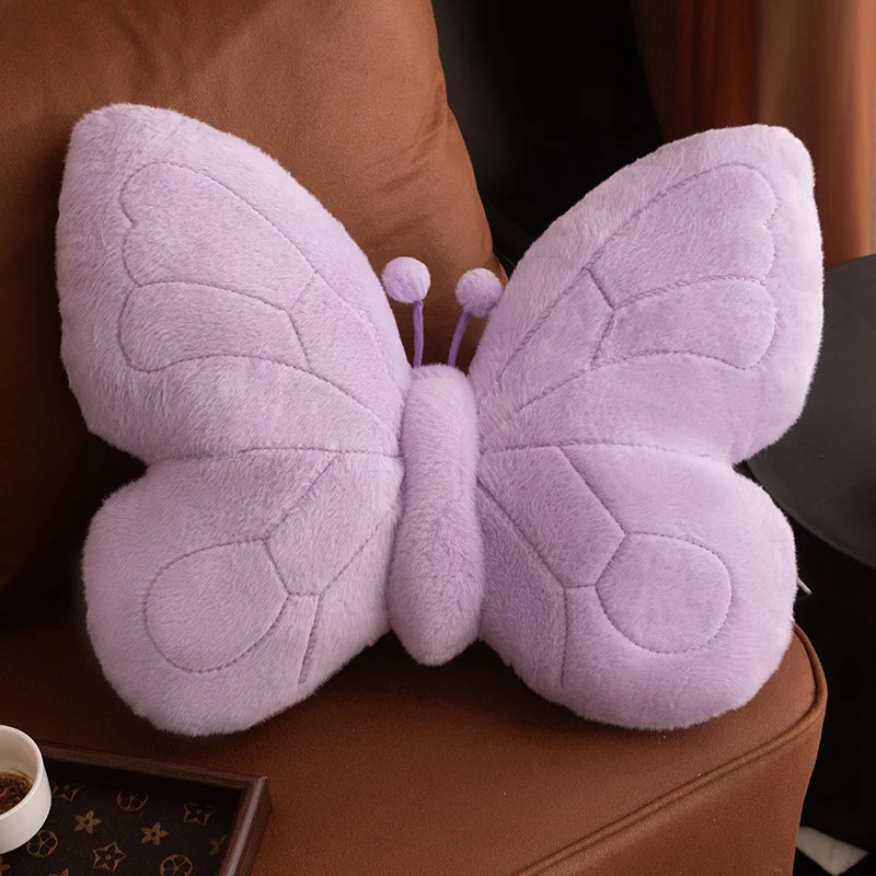 Purple butterfly-shaped kawaii pillow on a brown surface