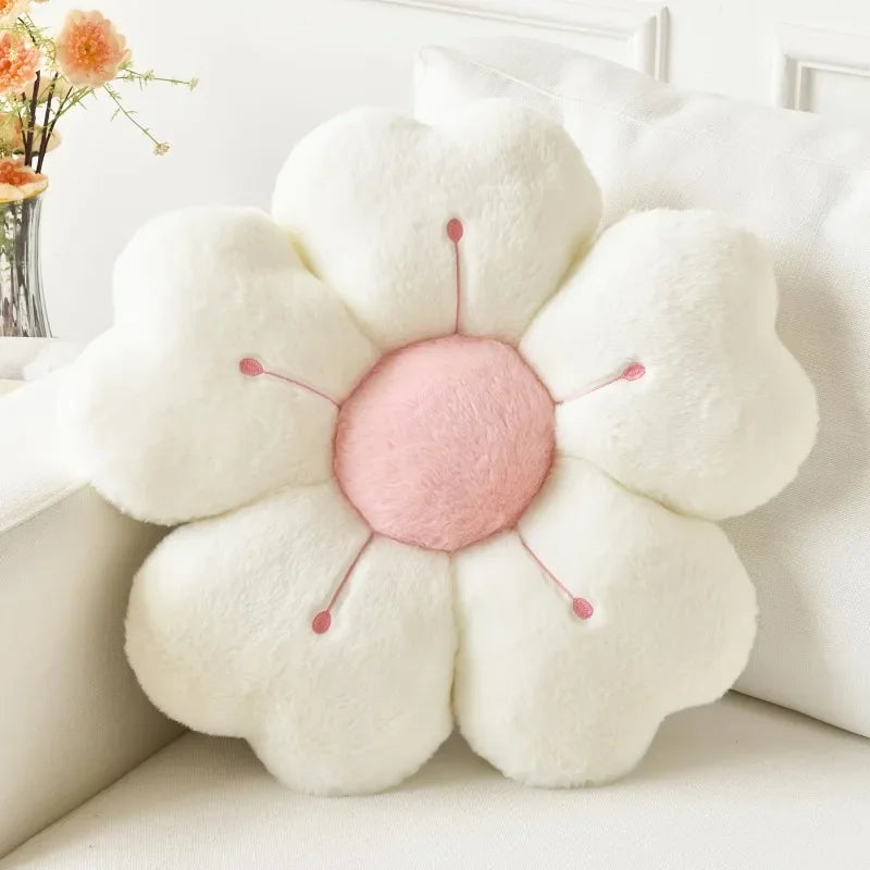 Flower-shaped kawaii pillow with a pink center on a white surface