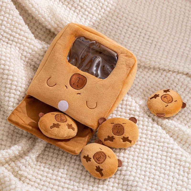 Kawaii plush toy resembling a cookie with small cookie toys on a textured beige surface